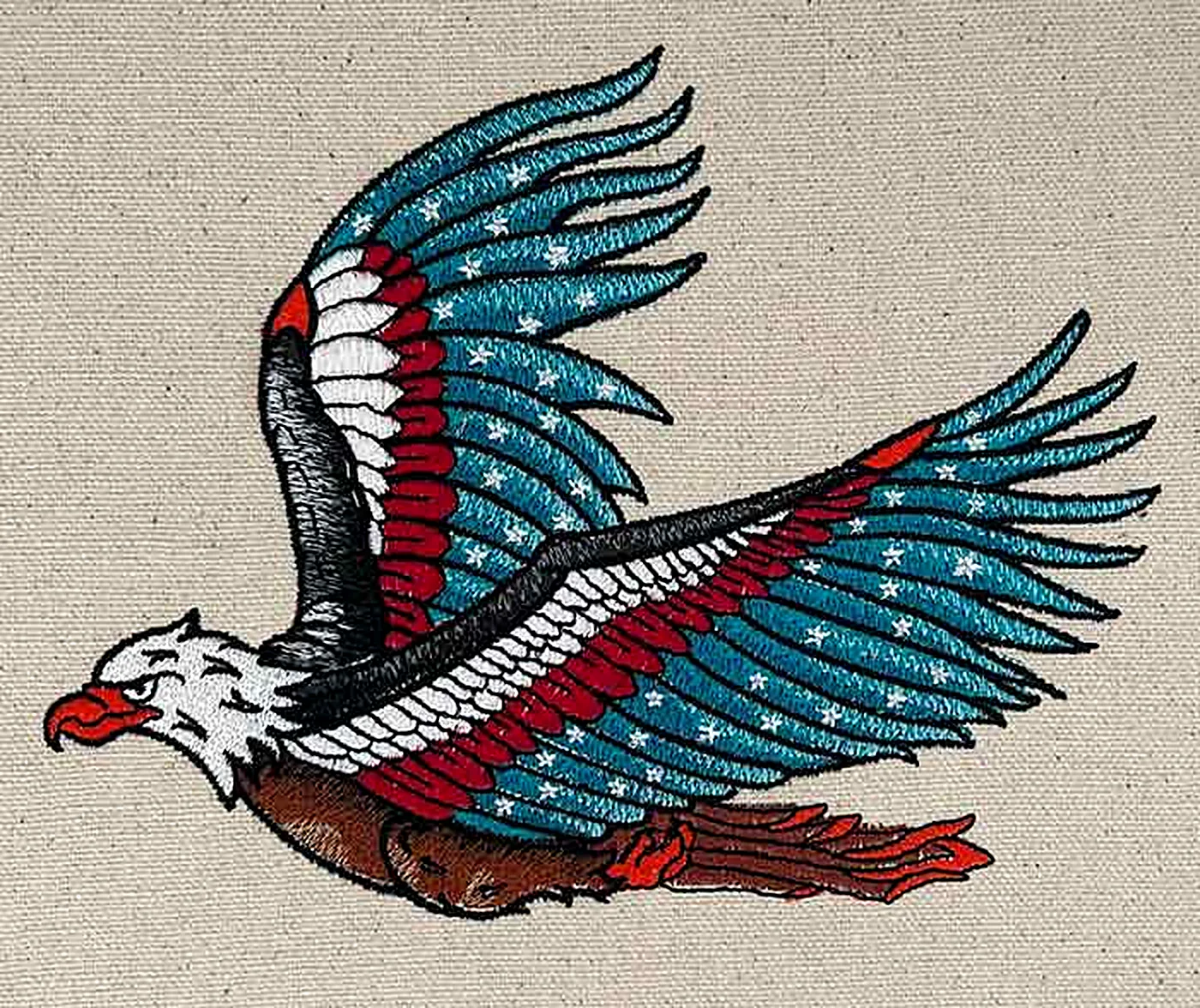 Embroidered eagle with flag-pattern wings sewn out on natural canvas